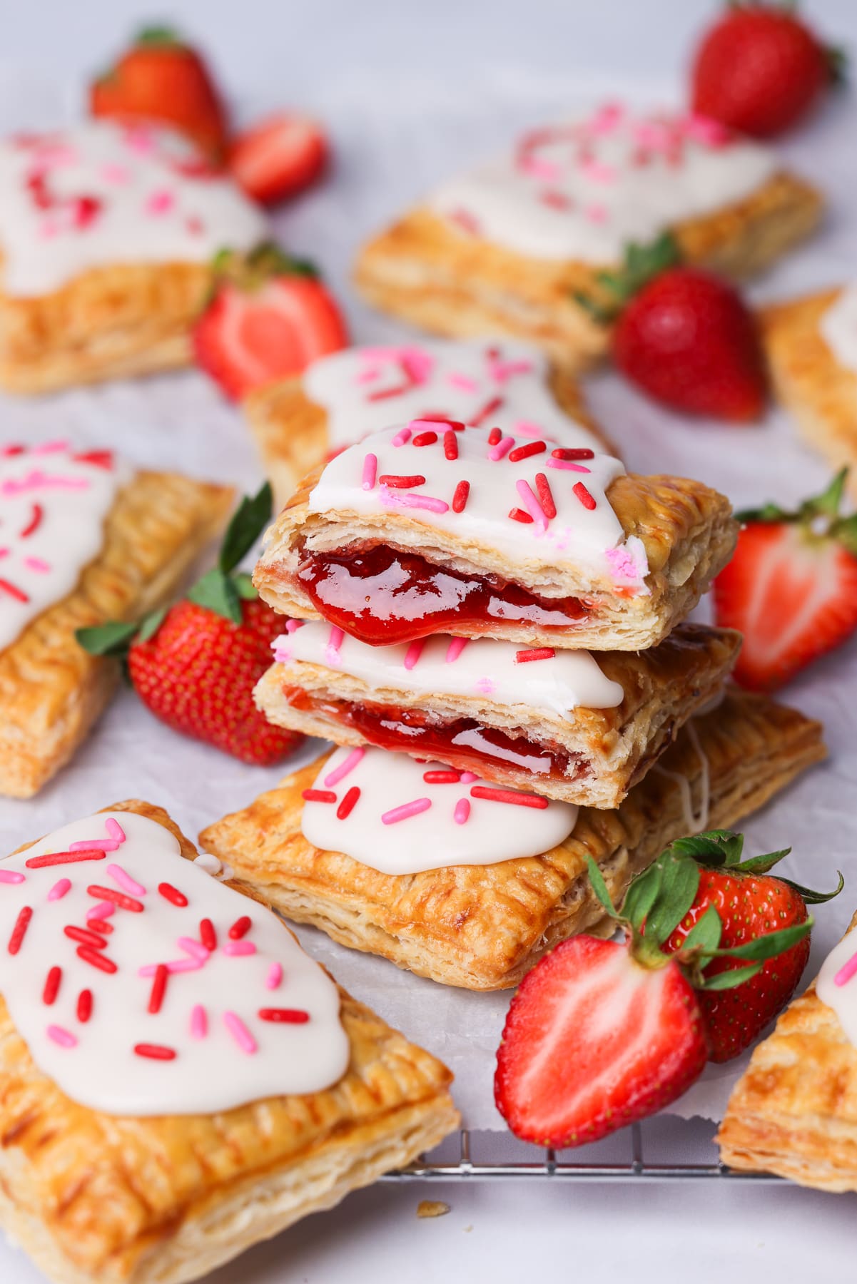a strawberry pop tart cut in half. it shows strawberry jam inside.