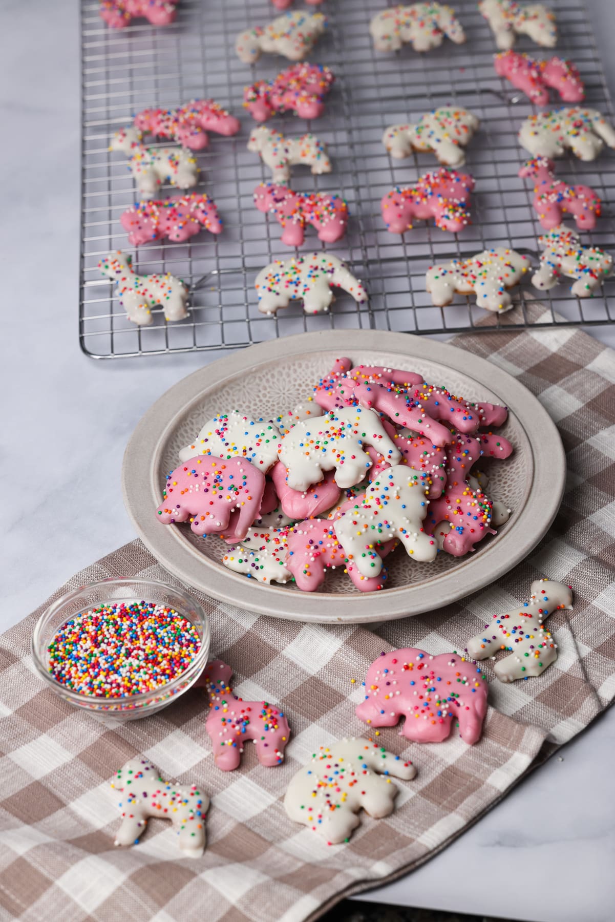 pink and white circus animal cookies on a table.